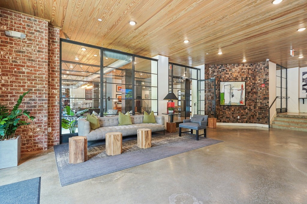 Entrance to The Kirkwood and the Resident clubhouse: couch and seating  with iron glass door and windows